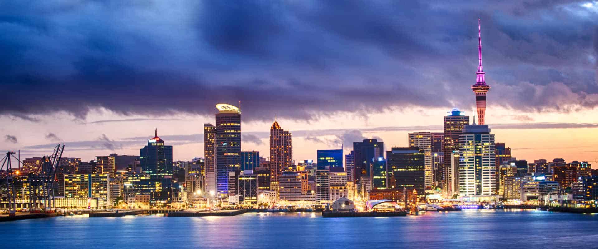 The Auckland city skyline at dusk, viewed across the harbour